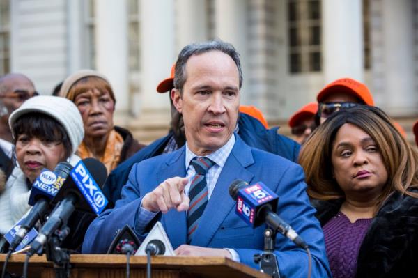 Jim Walden in a suit speaking into micropho<em></em>nes during a press co<em></em>nference at City Hall