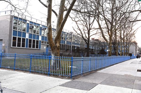 Outside of Origins HS in Sheepshead Bay, blue fence surrounding school