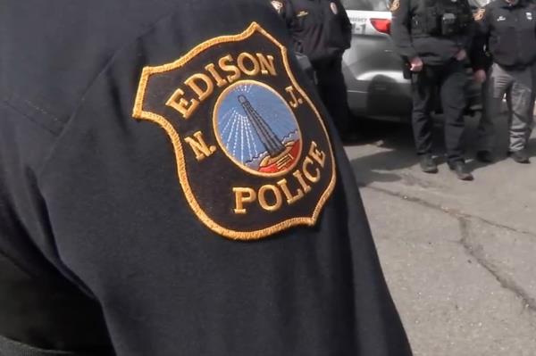 Edison NJ police badge patch on person's shoulder. 