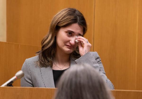 An emotio<em></em>nal Bre Micciolo sits at the witness stand as the the fitness center surveillance footage is played in court on April 30, 2024.  