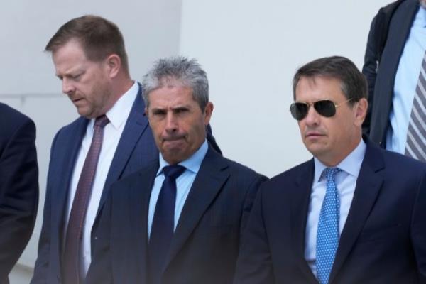 Carlos De Oliveira (center) the property manager of Do<em></em>nald Trump's Mar-a-Lago estate, leaves the Alto Lee Adams Sr US Courthouse on Thursday