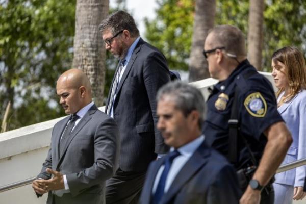 Do<em></em>nald Trump's staffers Walt Nauta (left) and Carlos De Oliveira (right) left after appear in in federal court in Florida on Thursday