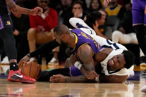 Lakers forward LeBron James (23) and Memphis Grizzlies forward Jaren Jackson Jr. (13) reach for a loose ball during the second half.