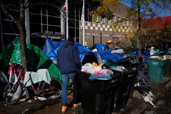 Migrants set up tents outside of a Chicago Police Department building.