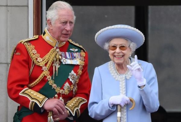 (FILES) In this file photo taken on June 2, 2022 Britain's Queen Elizabeth II (R) stands with Britain's Prince Charles, Prince of Wales to watch a special flypast from Buckingham Palace balcony following the Queen's Birthday Parade, the Trooping the Colour, as part of Queen Elizabeth II's platinum jubilee celebrations, in London. - The coro<em></em>nation ceremony of Britain's King Charles III and his wife, Britain's Camilla, Queen Consort, as King and Queen of the United Kingdom and Commo<em></em>nwealth Realm nations is scheduled to take place at Westminster Abbey, in London, on May 6, 2023. (Photo by Daniel LEAL / AFP) (Photo by DANIEL LEAL/AFP via Getty Images)