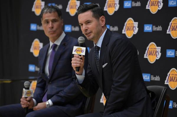 New Lakers coach JJ Redick (r.) speaks to the media on Mo<em></em>nday as GM Rob Pel<em></em>inka looks on.