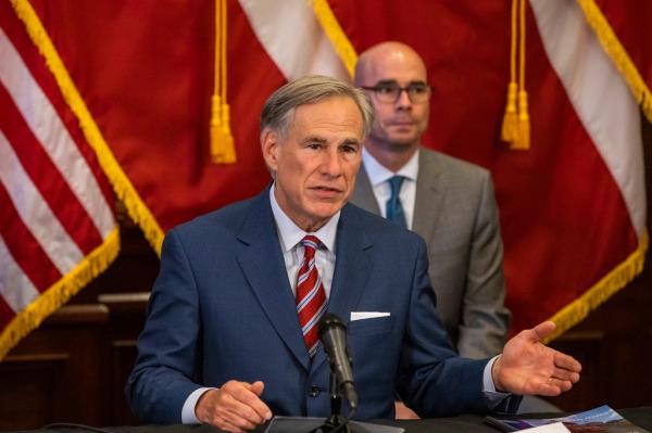 Texas Governor Greg Abbott, in a suit and tie, announcing the reopening of more Texas businesses during a press co<em></em>nference amid COVID-19 pandemic