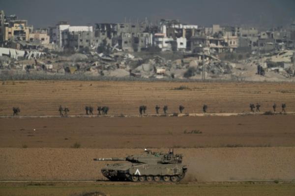 Israeli troops are seen near the Gaza Strip border, in southern Israel on Sunday, Dec. 10, 2023. (AP Photo/Leo Correa)