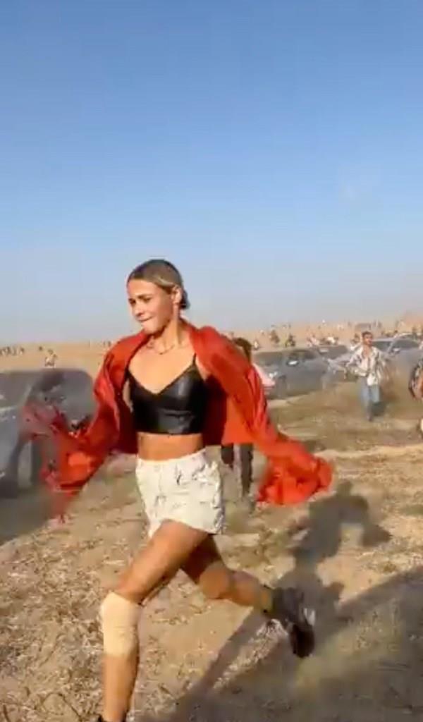 a Tribe of Nova music festival attendee runs from the terrorist attack during Hamas' initial incursion on Israel on Oct. 7.