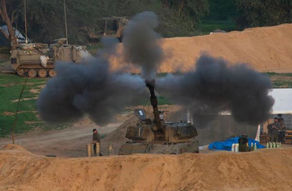 An Israeli 155 self-propelled Howitzer fires a shot toward the southern Gaza Strip during Israel's military operation in the area on Dec. 27, 2023.