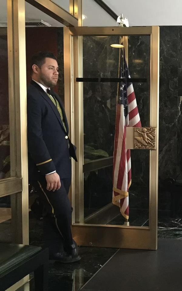 Doorman Stephen Bruno at the door of a fancy building. 