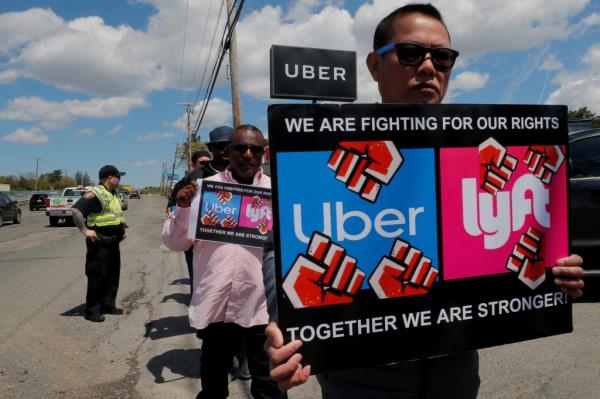 Uber and Lyft drivers protest during a day-long strike outside Uber's office in Saugus, Mass., in 2019.